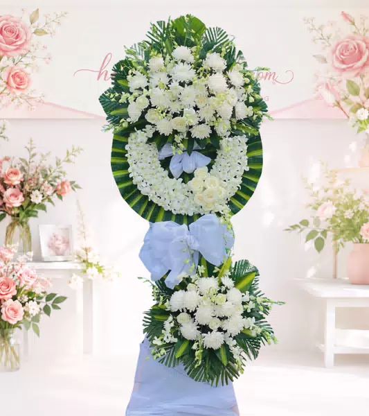 Kệ hoa tang lễ cúc trắng hồng trắng hai tầng nơ xanh