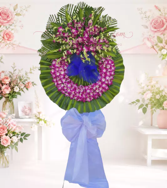 Vòng hoa chia buồn lan tím đậm nơ xanh dương